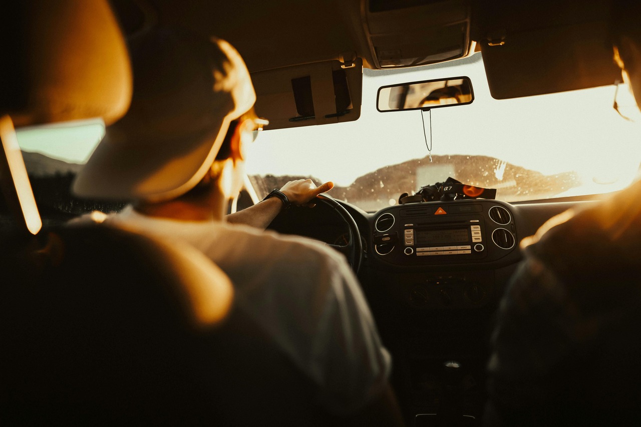 Young man looks through car windshield